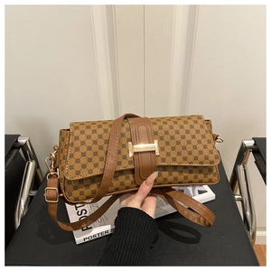 Detailed close-up of brown printed crossbody bag featuring golden H-shaped buckle closure
