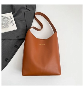Detailed top view of caramel brown faux leather tote bag with gold FASHION lettering