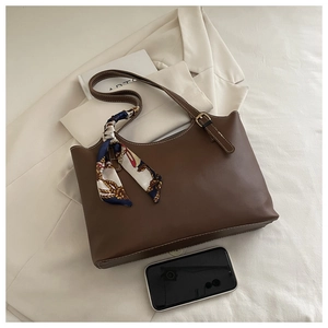 Brown leather tote bag featuring a decorative patterned silk scarf and large capacity