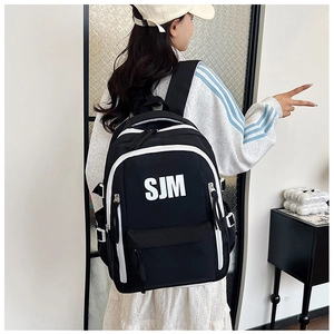 Detail of black nylon backpack with SJM logo and stylish white contrast trim details