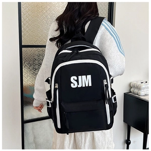 Detailed view of black contrast backpack featuring SJM logo and adjustable side buckles