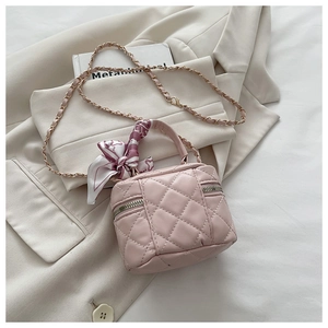 Detailed view of pink quilted mini crossbody bag with silk scarf and chain strap