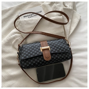 Detail view of small square bag with blue circular patterns and size comparison with phone