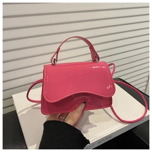 Detail of rose pink patent leather mini bag with wavy flap and glossy finish