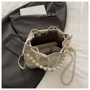 Internal view of blue jacquard bucket bag showing phone and makeup storage capacity
