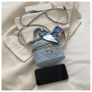 Mini light blue quilted bucket bag with floral scarf handle and gold chain strap