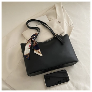 Detail of black tote bag with white stitching, vintage scarf and smartphone size reference