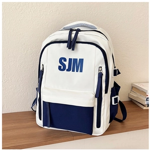 Detail of high-capacity contrast color backpack featuring the blue SJM logo print