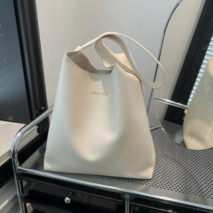 Minimalist beige tote bag with gold FASHION lettering for stylish women commuting