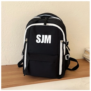 Detail of high-capacity black backpack with white SJM logo and contrast zippers