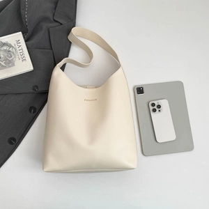 Minimalist beige tote bag with Fashion text shown with lifestyle accessories