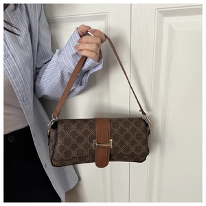 Detail of vintage brown monogram baguette bag with gold buckle and leather strap