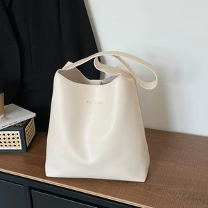 Minimalist cream tote bag in premium PU leather featuring gold fashion logo and top handles