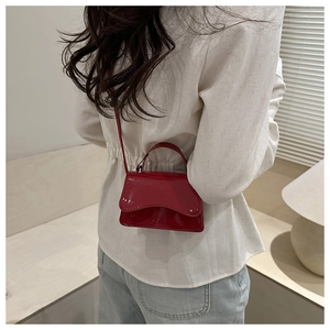Glossy red patent leather mini square bag shown on model for size and style reference