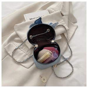 Capacity display of light blue cat-eared crossbody bag with makeup items inside