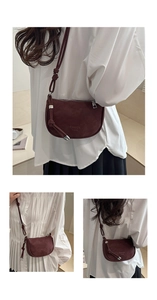 Detail of burgundy matte crossbody bag featuring knot strap and semi-circular silhouette