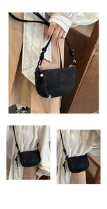 Detail of black matte saddle bag with knotted strap and silver hardware for daily wear