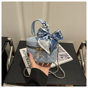 Light blue quilted mini handbag with decorative silk scarf and gold chain strap detail