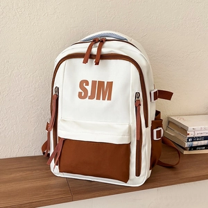 Large capacity colorblock school backpack with SJM logo and multiple storage pockets
