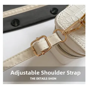 Detailed macro view of adjustable shoulder strap with premium golden metal buckles and clips
