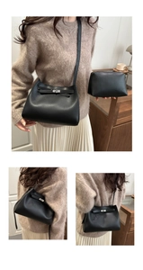 Detail view of black soft leather crossbody bag set with matching zip pouch on model