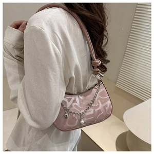 Pink matte leather underarm bag featuring silver heart chain and pearl detail
