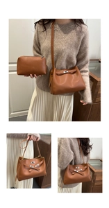 Detail of brown leather handbag set featuring silver metal lock and matching small pouch