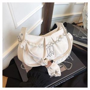 Detail of cream pleated shoulder bag with pearl and floral metal chain strap and logo patch