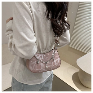 Pink crescent underarm bag with silver chain, pearl charm and heart pendant detail
