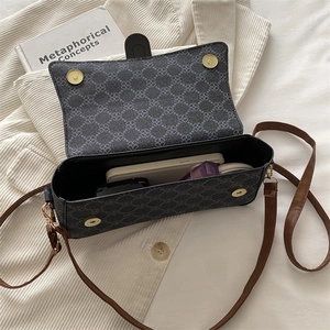 Elegant grey patterned shoulder bag with brown leather strap and spacious interior