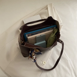 Retro brown faux leather tote bag showing large capacity with daily essentials