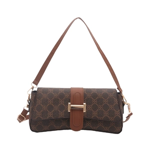 Brown rectangular shoulder bag with clover texture and gold buckle on white background
