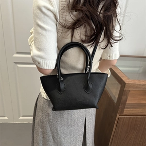 Minimalist black lychee pattern leather tote bucket bag with dual handles and shoulder strap