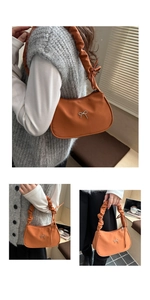 Detail of caramel orange nylon bag featuring silver metal bow and pleated shoulder strap
