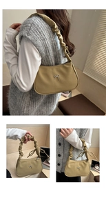 Detail of vintage yellow hobo bag with metallic bow and scrunchie shoulder strap