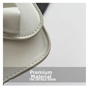 Close-up of cream white lychee leather texture and precise stitching on the crossbody bag