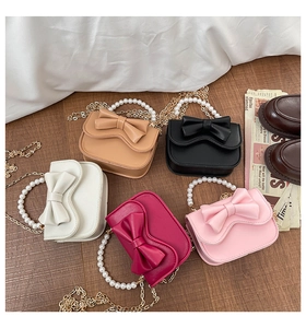 Collection of five mini crossbody bags with pearl handles and decorative bows in various colors