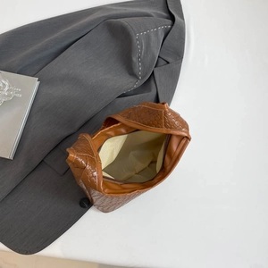Brown woven tote bag featuring a spacious interior and a secure zippered inner pocket