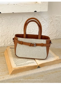 Close-up of minimalist retro handbag with brown leather and beige canvas textures