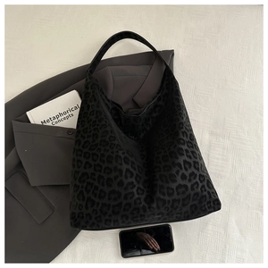 Macro view of leopard print texture and soft suede fabric on this spacious hobo tote bag