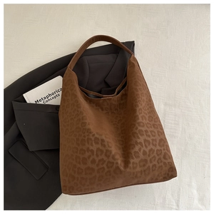 Detail of dark brown leopard print tote bag in soft suede fabric for winter style