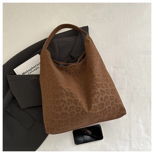 Detailed top view of large leopard print tote bag with soft suede texture and wide strap