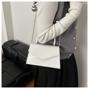 White envelope shoulder bag with glossy PU texture and elegant gold chain strap details