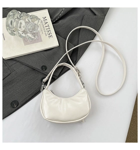 Detailed 45-degree angle of white PU crescent bag with bow accent and dual straps