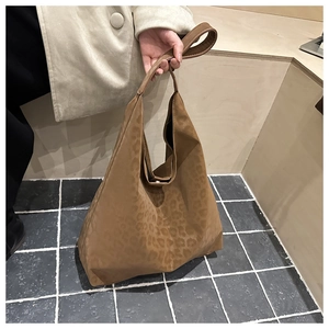 Detailed view of the leopard print texture on a plush suede tote bag for women