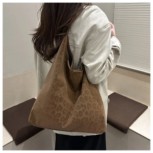 Brown leopard print hobo shoulder bag shown on model for a stylish casual daily commute