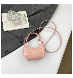 Vue de dessus d'un mini sac hobo rose avec un détail de nœud perlé sur un blazer gris