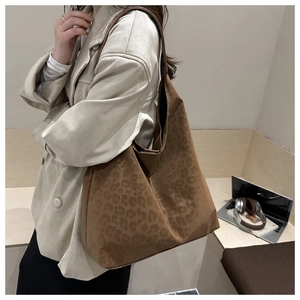 Detailed shot of large capacity leopard print tote bag worn on shoulder for daily use