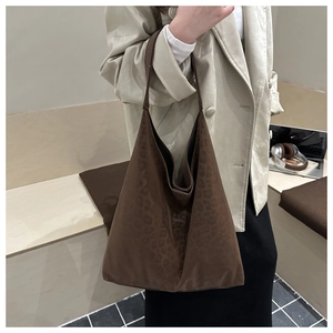Brown leopard print suede tote bag styled with a beige blazer for chic autumn fashion