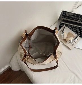 Detail view of large tote bag interior showing spacious capacity and gold chain detail